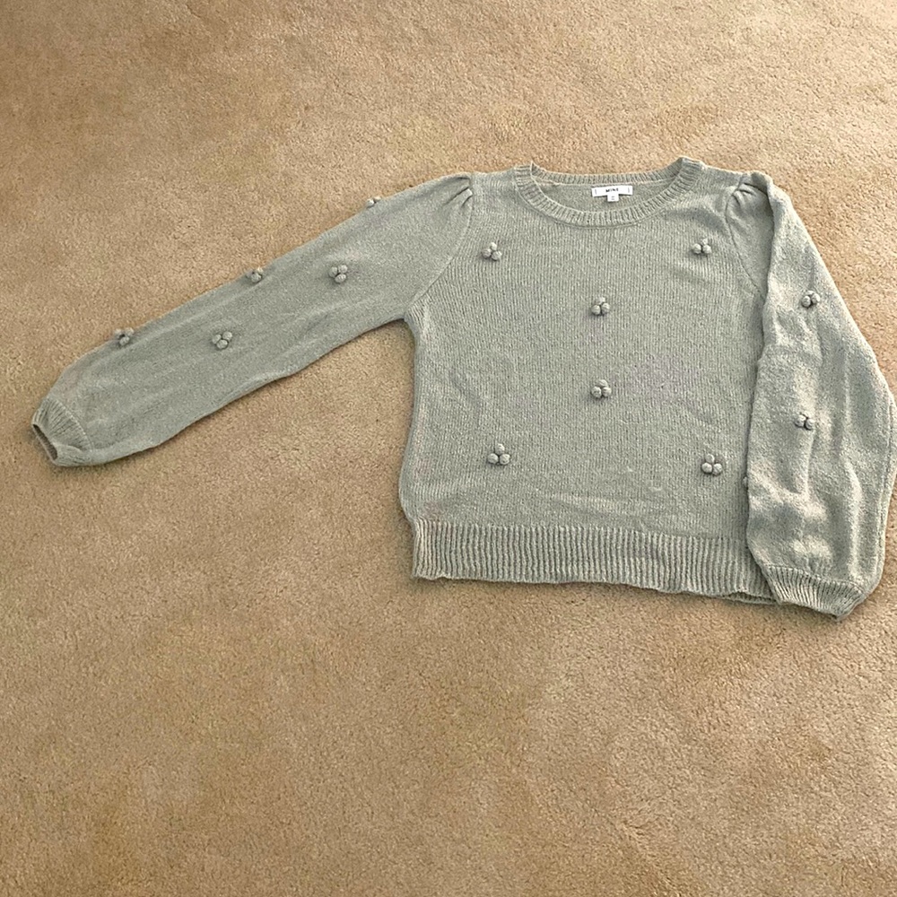 Lightweight sweater with pom detail. Never worn. Excellent condition.